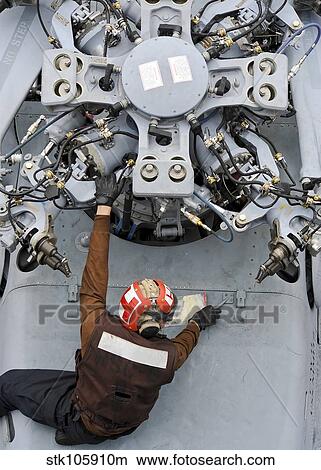 Mechanic performs an inspection on a MH-60S Seahawk. View Large Photo Image Picture - Mechanic performs an inspection on a MH-60S Seahawk.. Fotosearch