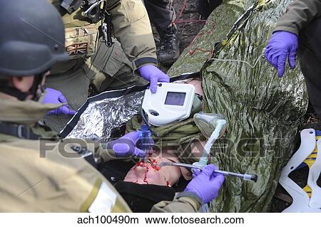 Picture - Medics of the British Special Forces provide first aid to a simulated victim.. Fotosearch