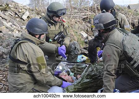 Picture - Medics of the British Special Forces provide first aid to a simulated victim.. Fotosearch