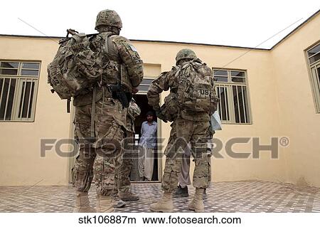 Members of Provincial Reconstruction Team Farah prepare to enter a building. View Large Photo Image Picture - Members of Provincial Reconstruction Team Farah prepare to enter a building.. Fotosearch