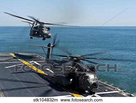 MH-53E Sea Dragon helicopters take off from the flight deck of USS Wasp. View Large Photo Image Picture - MH-53E Sea Dragon helicopters take off from the flight deck of USS Wasp.. Fotosearch