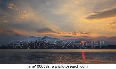 Stock Photograph - Midnight Sun over Tjeldsundet strait in Troms County, Norway.. Fotosearch