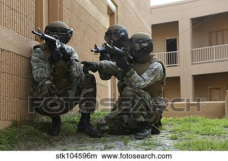 Midshipmen take cover during urban combat training. View Large Photo Image Picture - Midshipmen take cover during urban combat training.. Fotosearch