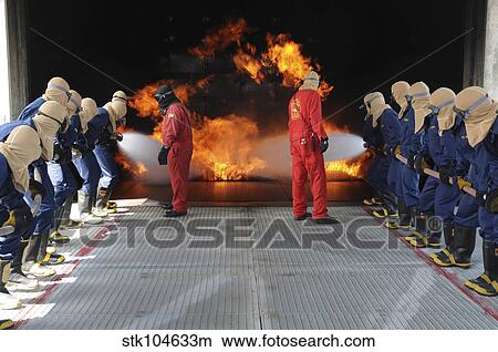 Midshipmen work together to battle a fire. View Large Photo Image Picture - Midshipmen work together to battle a fire.. Fotosearch