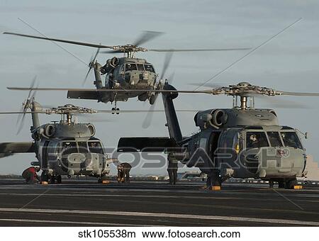Military helicopters land on the flight deck of USS Carl Vinson. View Large Photo Image Picture - Military helicopters land on the flight deck of USS Carl Vinson.. Fotosearch