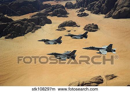 Military planes flying over the Wadi Rum desert in Jordan. View Large Photo Image Picture - Military planes flying over the Wadi Rum desert in Jordan.. Fotosearch