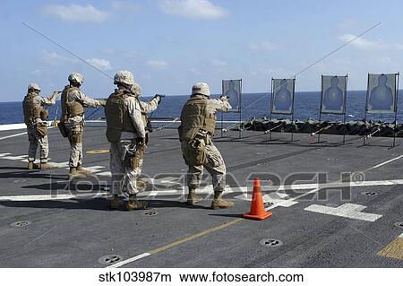 Picture - Military policemen train with the Berretta M9 9mm pistol aboard USS San Antonio.. Fotosearch