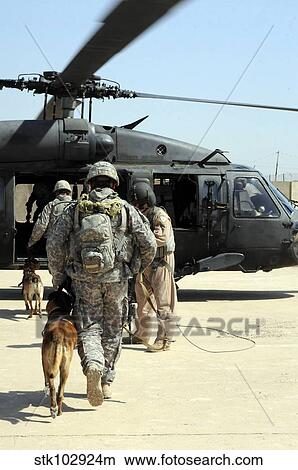 Military working dog handlers board a helicopter. View Large Photo Image Picture - Military working dog handlers board a helicopter.. Fotosearch