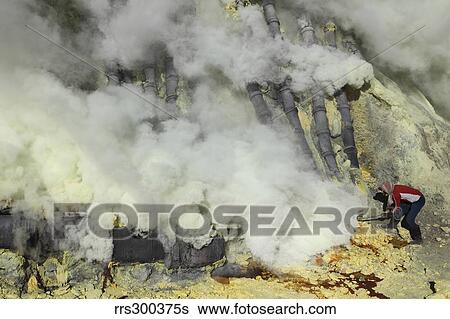 Miner breaking up sulphur deposits at Kawah Ijen Volcano, Java, Indonesia. View Large Photo Image Stock Photograph - Miner breaking up sulphur deposits at Kawah Ijen Volcano, Java, Indonesia.. Fotosearch
