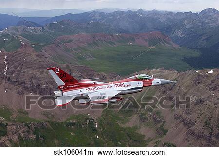 Minute Men paint scheme on an F-16 Fighting Falcon over Rocky Mountains. View Large Photo Image Picture - Minute Men paint scheme on an F-16 Fighting Falcon over Rocky Mountains.. Fotosearch