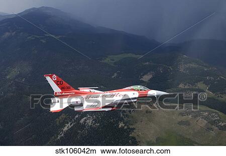 Picture - Minute Men paint scheme on an F-16 Fighting Falcon over Rocky Mountains.. Fotosearch