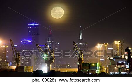 Stock Photograph - Moonrise over city of Melbourne, Australia.. Fotosearch