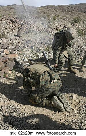 Mortarmen cover their ears and avert their eyes after firing their 60mm mortar weapons. View Large Photo Image Picture - Mortarmen cover their ears and avert their eyes after firing their 60mm mortar weapons.. Fotosearch