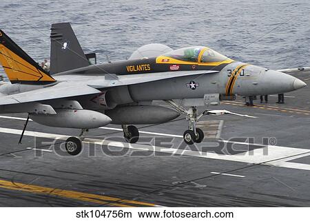 Picture - n F/A-18F Super Hornet lands aboard the aircraft carrier USS Abraham Lincoln.. Fotosearch