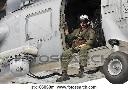 Naval Aircrewman acts in an SH-60B Sea Hawk helicopter. View Large Photo Image Picture - Naval Aircrewman acts in an SH-60B Sea Hawk helicopter.. Fotosearch