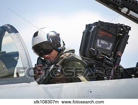 Naval aviator performs pre-flight checks on an F/A-18C Hornet. View Large Photo Image Picture - Naval aviator performs pre-flight checks on an F/A-18C Hornet.. Fotosearch