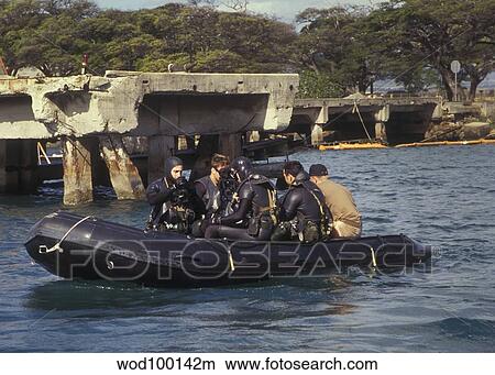 Picture - Navy Seals combat swimmers sitting in a combat rubber raiding craft, Oahu, Hawaii.. Fotosearch