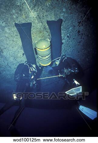 Navy SEALs emplace a live demolition under a ship's hull. View Large Photo Image Picture - Navy SEALs emplace a live demolition under a ship's hull.. Fotosearch