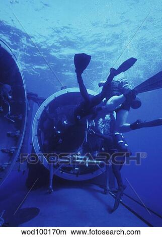 Navy SEALs submerge and lock back into the Dry Deck Shelter. View Large Photo Image Picture - Navy SEALs submerge and lock back into the Dry Deck Shelter.. Fotosearch