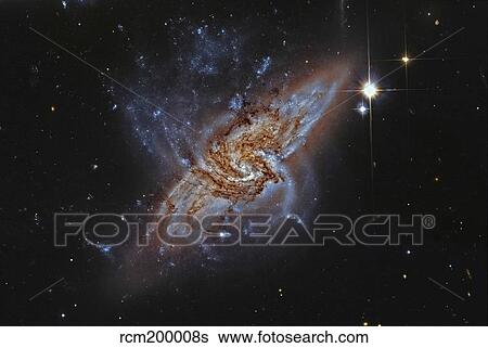 Stock Photograph - NGC 3314, a pair of overlapping spiral galaxies.. Fotosearch