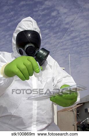Picture - Officer holds a chemical testing kit.. Fotosearch