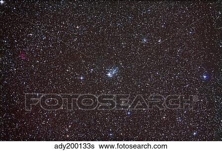 Stock Photograph - Open cluster NGC 457 in the constellation Cassiopeia.. Fotosearch