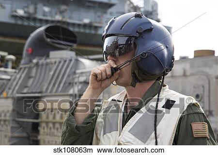 Operations Specialist radios instructions from a landing craft air cushion. View Large Photo Image Picture - Operations Specialist radios instructions from a landing craft air cushion.. Fotosearch