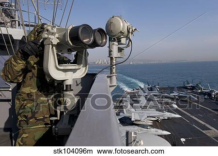Operations Specialist Seaman stands as lookout watch on USS Carl Vinson. View Large Photo Image Picture - Operations Specialist Seaman stands as lookout watch on USS Carl Vinson.. Fotosearch