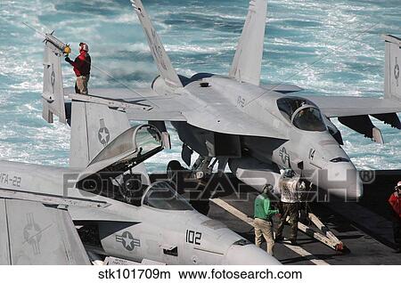 Ordnancemen perform checks on a F/A-18E Super Hornet aircraft. View Large Photo Image Picture - Ordnancemen perform checks on a F/A-18E Super Hornet aircraft.. Fotosearch