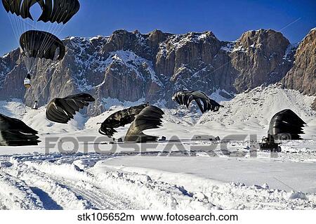 Pallets of supplies land in the snow-covered ground during an airdrop in Afghanistan. View Large Photo Image Picture - Pallets of supplies land in the snow-covered ground during an airdrop in Afghanistan.. Fotosearch
