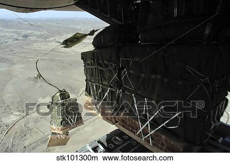 Pallets roll out of a C-130 Hercules. View Large Photo Image Picture - Pallets roll out of a C-130 Hercules.. Fotosearch