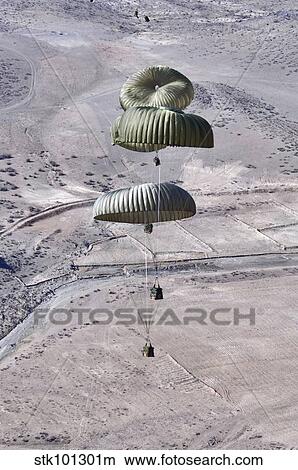 Pallets roll out of a C-130 Hercules. View Large Photo Image Picture - Pallets roll out of a C-130 Hercules.. Fotosearch