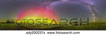 Stock Photograph - Panorama of an aurora and the Milky Way at a ranch in Canada.. Fotosearch