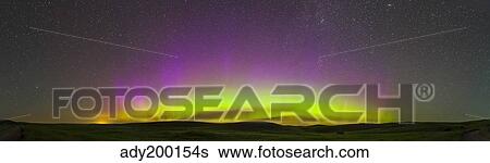Stock Photograph - Panoramic view of northern lights on the horizon, Saskatchewan, Canada.. Fotosearch