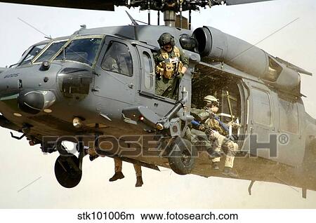 Pararescuemen aboard a helicopter prepare for landing. View Large Photo Image Picture - Pararescuemen aboard a helicopter prepare for landing.. Fotosearch