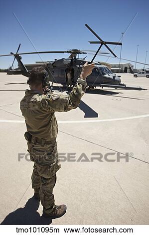 Pararescuemen conducts a communications check with his Sat radio. View Large Photo Image Picture - Pararescuemen conducts a communications check with his Sat radio.. Fotosearch