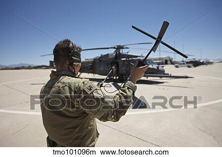 Pararescuemen conducts a communications check with his Sat radio. View Large Photo Image Picture - Pararescuemen conducts a communications check with his Sat radio.. Fotosearch