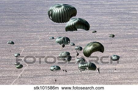 Pararescuemen jump out of a C-130 Hercules. View Large Photo Image Picture - Pararescuemen jump out of a C-130 Hercules.. Fotosearch