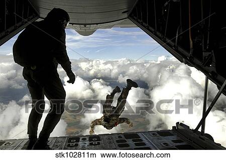 Pararescuemen jump out the back of a C-130 Hercules. View Large Photo Image Picture - Pararescuemen jump out the back of a C-130 Hercules.. Fotosearch