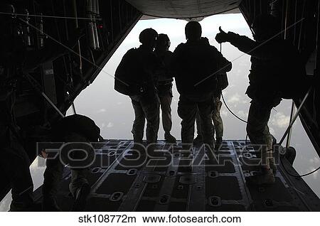 Pararescuemen prepare for a HALO jump aboard an HC-130 over Djibouti. View Large Photo Image Picture - Pararescuemen prepare for a HALO jump aboard an HC-130 over Djibouti.. Fotosearch