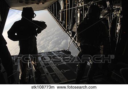 Pararescuemen prepare for a HALO jump aboard an HC-130 over Djibouti. View Large Photo Image Picture - Pararescuemen prepare for a HALO jump aboard an HC-130 over Djibouti.. Fotosearch