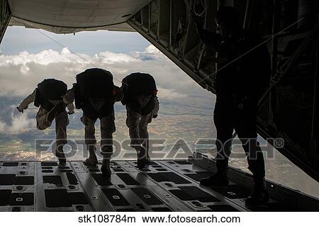 Paratroopers jump out of a KC-130J aircraft over Spain. View Large Photo Image Picture - Paratroopers jump out of a KC-130J aircraft over Spain.. Fotosearch