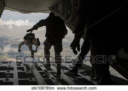Paratroopers jump out of a KC-130J aircraft over Spain. View Large Photo Image Picture - Paratroopers jump out of a KC-130J aircraft over Spain.. Fotosearch