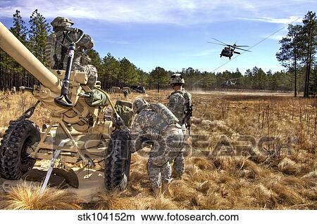 Paratroopers prepare to hook up an M119A2 howitzer to a UH-60M Black Hawk. View Large Photo Image Picture - Paratroopers prepare to hook up an M119A2 howitzer to a UH-60M Black Hawk.. Fotosearch