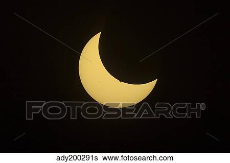 Partial eclipse of the Sun as seen from Jasper, Alberta, Canada. View Large Photo Image Stock Photograph - Partial eclipse of the Sun as seen from Jasper, Alberta, Canada.. Fotosearch