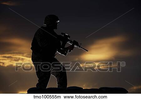 Partially silhouetted U. S. Marine on a bunker in Northern Afghanistan. View Large Photo Image Picture - Partially silhouetted U. S. Marine on a bunker in Northern Afghanistan.. Fotosearch