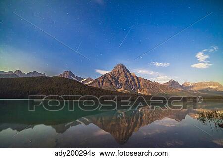 Perseid meteors over Mt. Chephren in Banff National Park, Canada. View Large Photo Image Stock Photograph - Perseid meteors over Mt. Chephren in Banff National Park, Canada.. Fotosearch