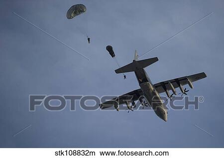 Picture - Personnel jump from a C-130 Hercules during a static-line jump.. Fotosearch