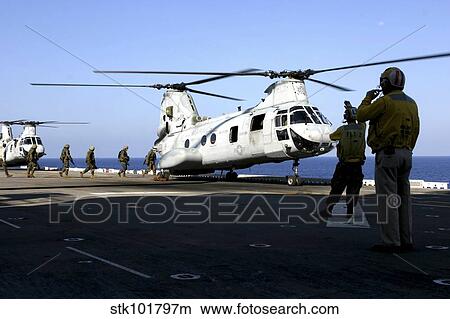 Personnel walk into the rear of a CH-46E Sea Knight helicopter. View Large Photo Image Picture - Personnel walk into the rear of a CH-46E Sea Knight helicopter.. Fotosearch