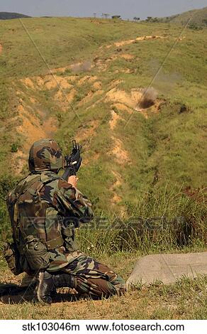 Petty Officer fires off a 40mm Highly Explosive round at Camp Hansen, Okinawa, Japan. View Large Photo Image Picture - Petty Officer fires off a 40mm Highly Explosive round at Camp Hansen, Okinawa, Japan.. Fotosearch